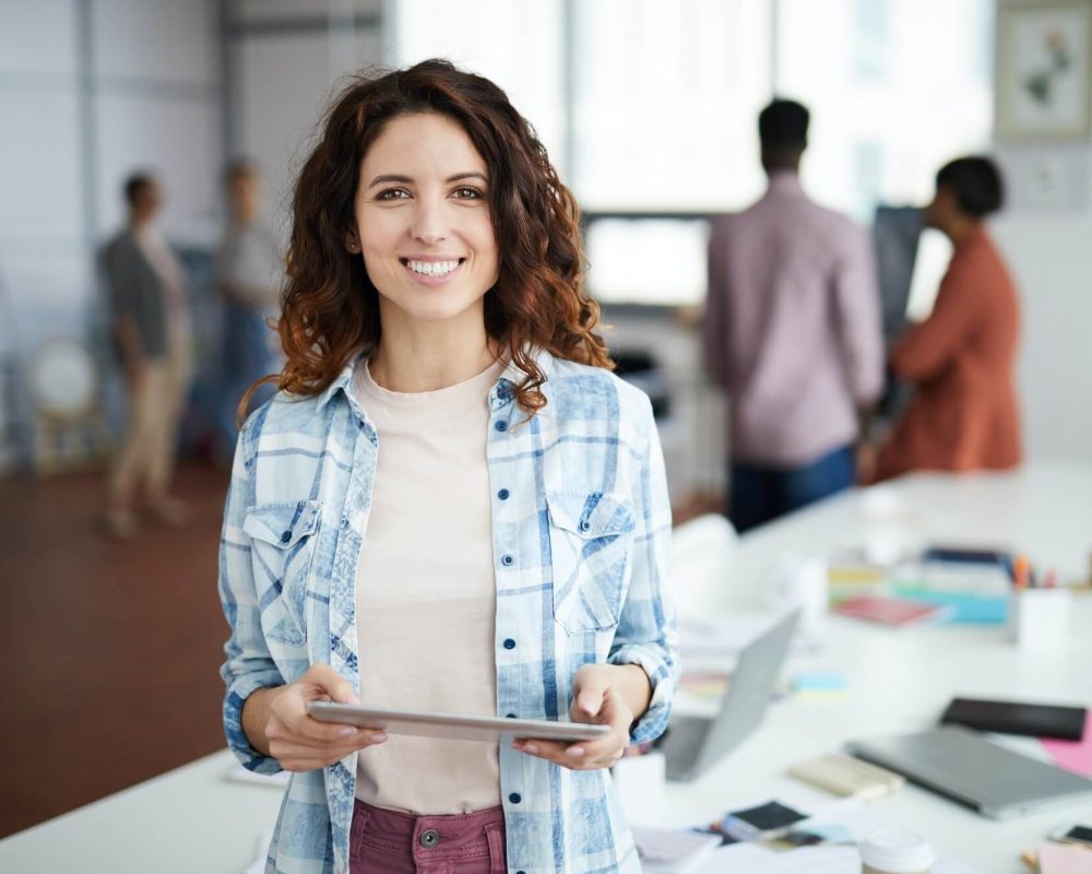 cheerful-young-woman-posing-in-creative-agency-1.jpg